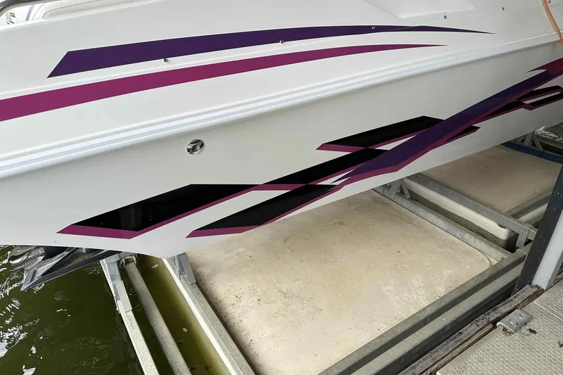 Slide: The Image of 1997 Fountain 29 Fever boat with purple and black geometric graphics on the hull. - 17