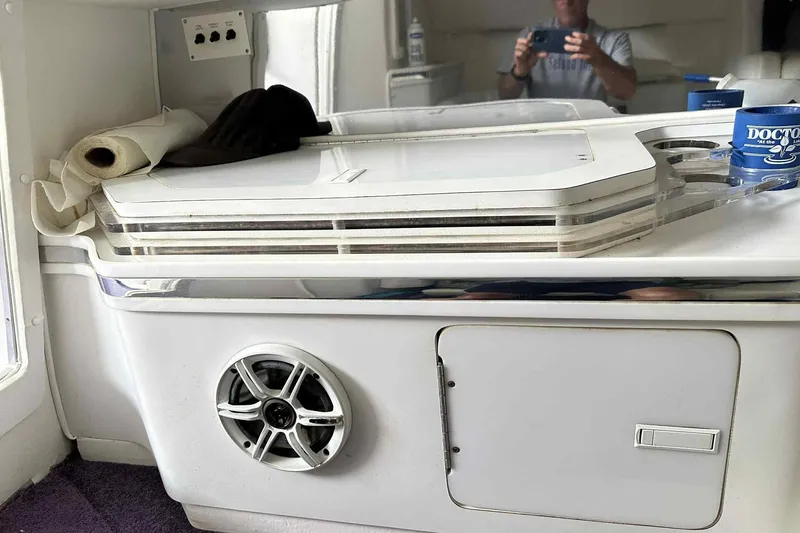 Slide: The Image of Interior of a 1997 Fountain 29 Fever boat with speaker and storage compartment. - 18