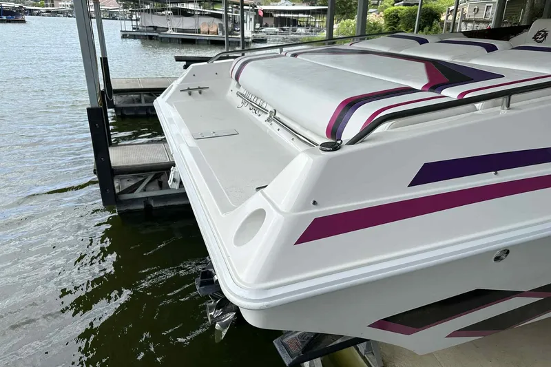Slide: The Image of 1997 Fountain 29 Fever boat docked, featuring sleek design and vibrant purple accents. - 26