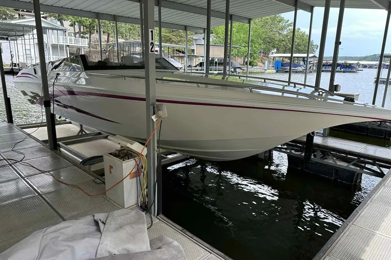 Slide: The Image of 1997 Fountain 29 Fever boat docked in covered marina slip. - 27