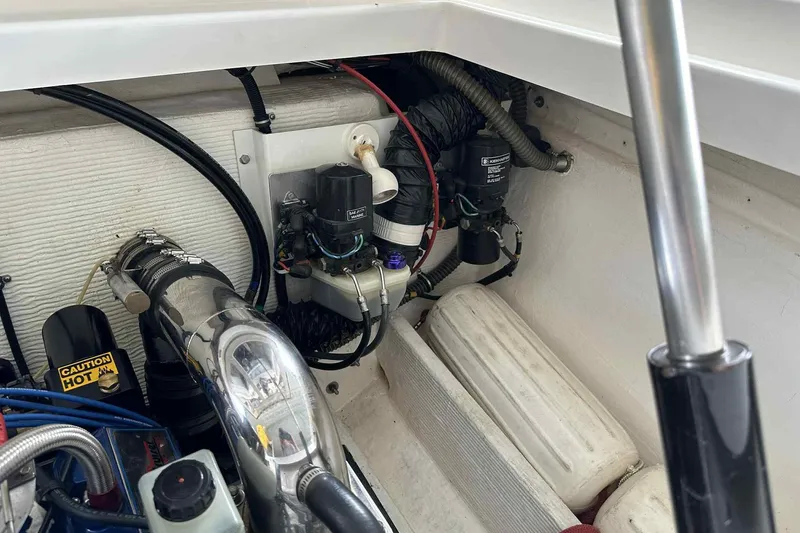 Slide: The Image of Engine compartment of a 1997 Fountain 29 Fever boat, showing mechanical components. - 29