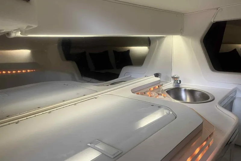 Slide: The Image of Interior of a 1997 Fountain 29 Fever boat with sleek white cabinetry and sink. - 3
