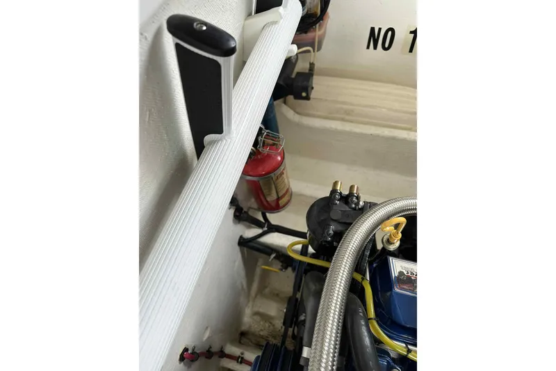 Slide: The Image of Engine compartment of a 1997 Fountain 29 Fever boat with visible fire extinguisher. - 30