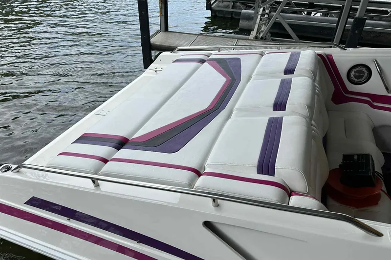 Slide: The Image of 1997 Fountain 29 Fever boat with colorful upholstery, docked by the water. - 31