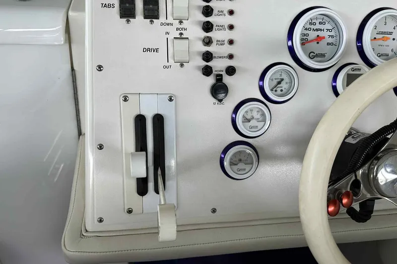 Slide: The Image of Control panel of a 1997 Fountain 29 Fever boat with gauges and switches. - 5