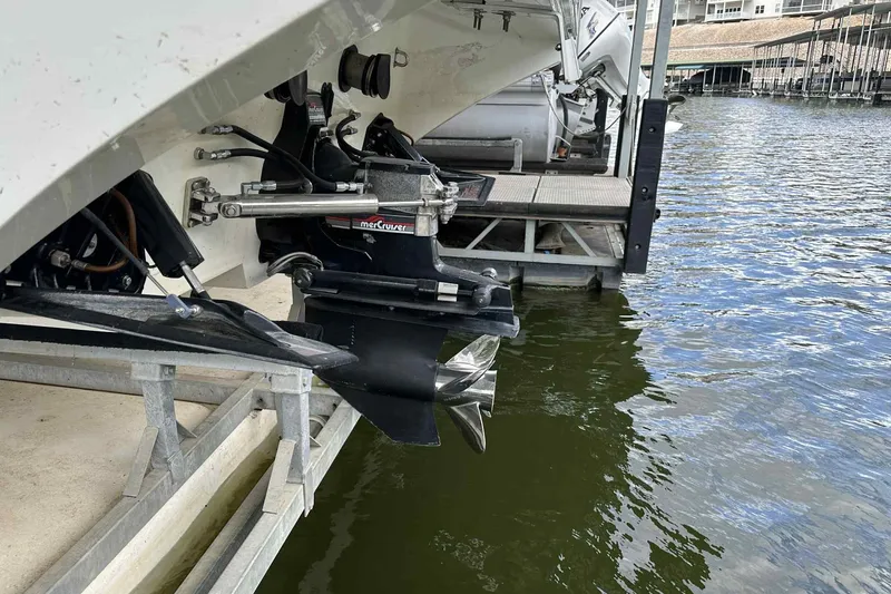 Slide: The Image of 1997 Fountain 29 Fever boat with MerCruiser outdrive, docked by the water. - 6