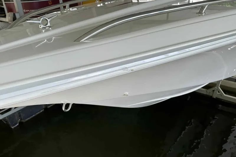 Slide: The Image of 1997 Fountain 29 Fever boat, sleek white hull, docked in marina. - 8