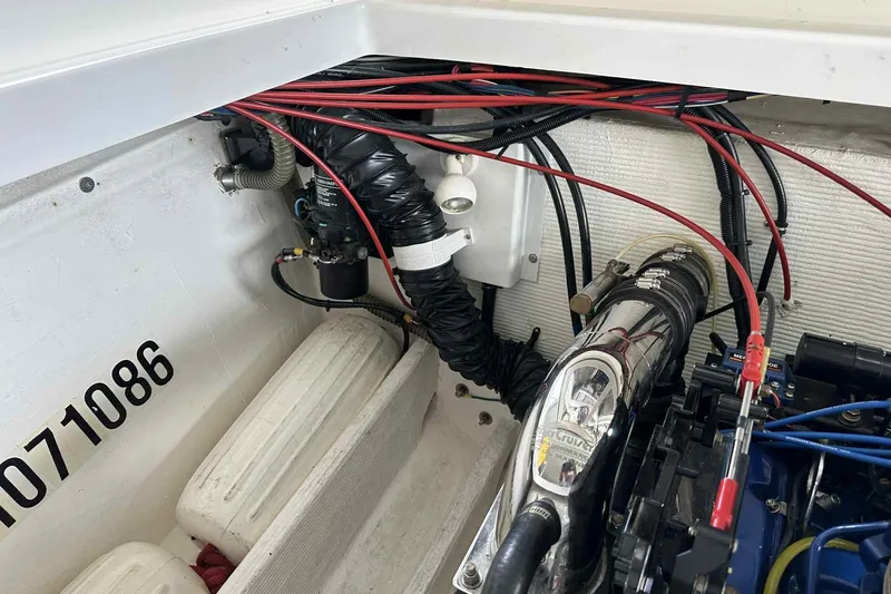 Slide: The Image of Engine compartment of a 1997 Fountain 29 Fever boat, showing wiring and components. - 9