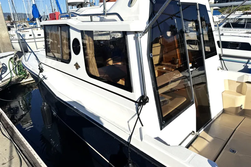 Slide: The Image of 2019 Ranger Tugs R-23 boat docked at marina, side view. - 1