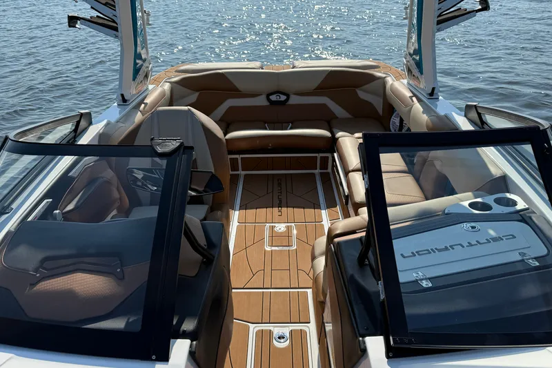 Slide: The Image of 2023 Centurion Ri230 boat interior with luxurious seating and open water view. - 21