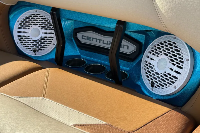 Slide: The Image of 2023 Centurion Ri230 boat interior with speakers and cup holders. - 23