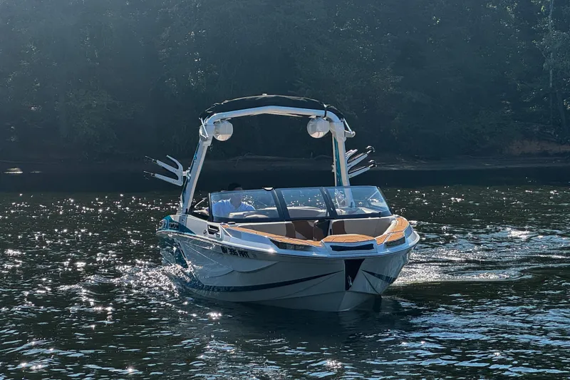 Slide: The Image of 2023 Centurion Ri230 boat cruising on a sunlit lake. - 6