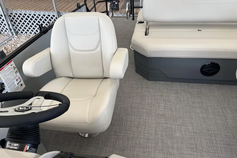 Slide: The Image of Interior of 2026 Sylvan MIRAGE 822 CLZ DH boat with plush seating and steering wheel. - 10