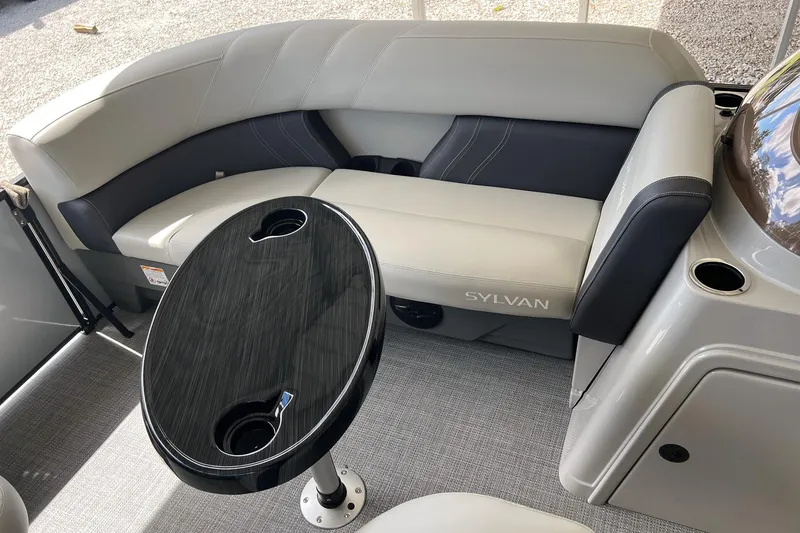 Slide: The Image of 2026 Sylvan MIRAGE 822 CLZ DH boat interior with sleek seating and modern table design. - 15
