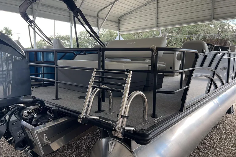 Slide: The Image of 2026 Sylvan MIRAGE 822 CLZ DH pontoon boat with seating and ladder, under a metal canopy. - 4