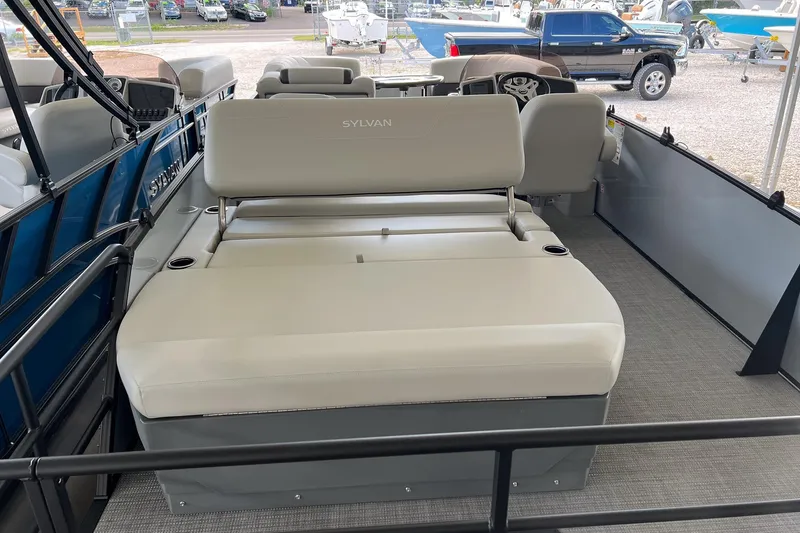 Slide: The Image of 2026 Sylvan MIRAGE 822 CLZ DH boat interior with beige seating and cup holders. - 6