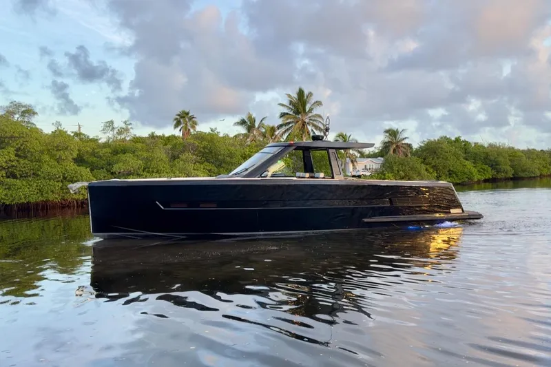 The Image of 2016 Fjord 48 Open yacht cruising on a serene waterway with lush greenery. - 0