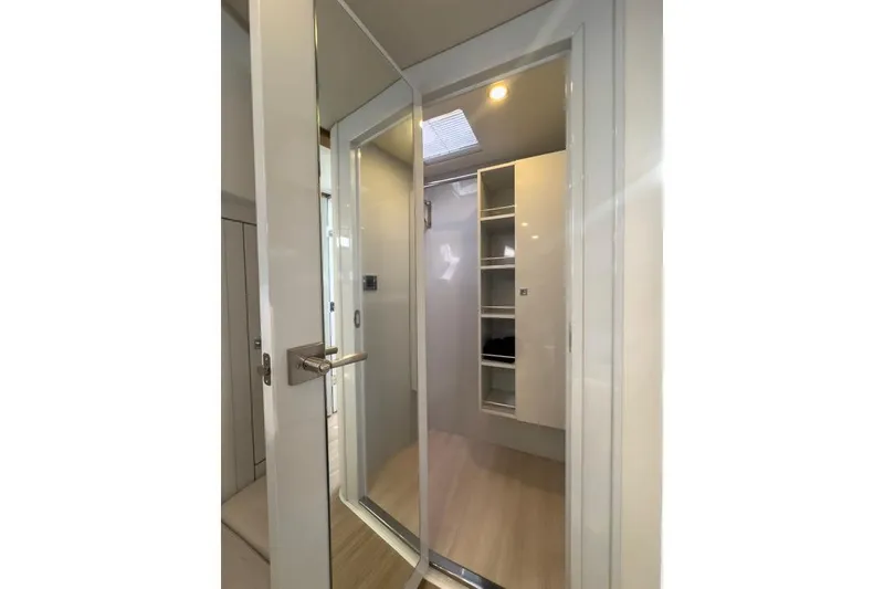 Slide: The Image of Interior of 2016 Fjord 48 Open yacht, featuring a modern closet space. - 18