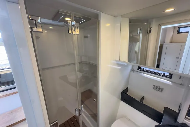Slide: The Image of Modern bathroom interior on a 2016 Fjord 48 Open yacht, featuring a glass shower enclosure. - 26