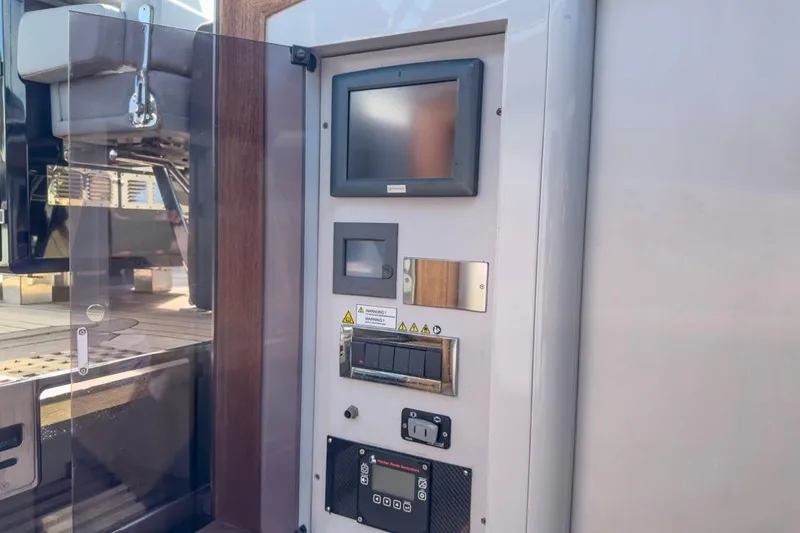 Slide: The Image of Control panel on a 2016 Fjord 48 Open yacht, featuring screens and switches. - 29