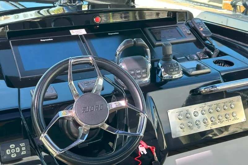 Slide: The Image of Helm of 2016 Fjord 48 Open yacht with advanced navigation controls and steering wheel. - 38