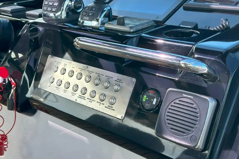 Slide: The Image of Control panel of a 2016 Fjord 48 Open yacht with various switches and devices. - 42