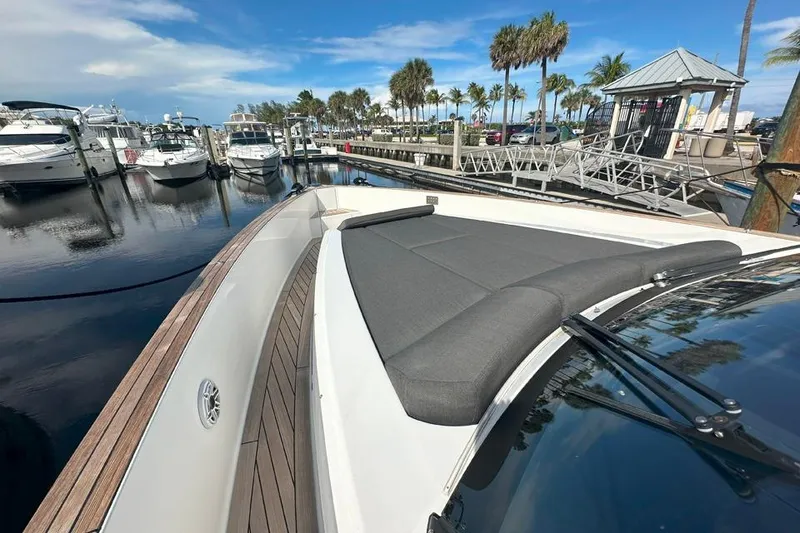 Slide: The Image of 2016 Fjord 48 Open yacht docked at a marina with palm trees. - 47
