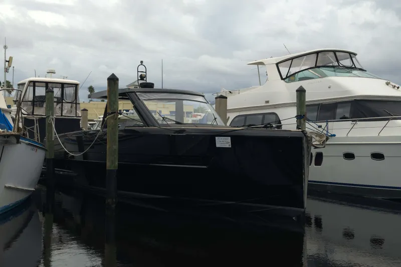 Slide: The Image of 2016 Fjord 48 Open yacht docked among other boats on a cloudy day. - 5