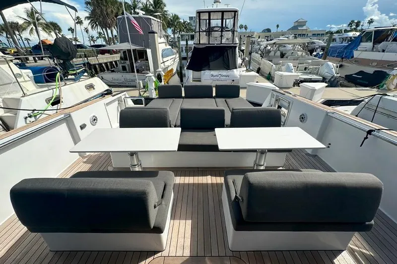 Slide: The Image of Luxurious 2016 Fjord 48 Open yacht with elegant seating and tables at a marina. - 51