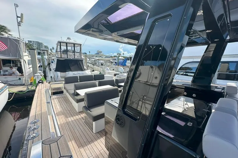 Slide: The Image of Luxurious 2016 Fjord 48 Open yacht docked, featuring sleek design and spacious seating. - 56