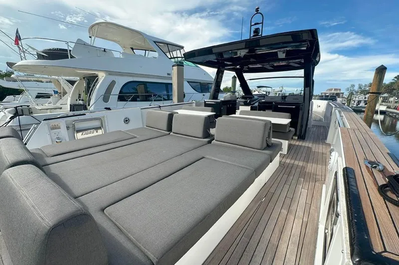Slide: The Image of 2016 Fjord 48 Open yacht with spacious deck and luxurious seating at marina. - 58