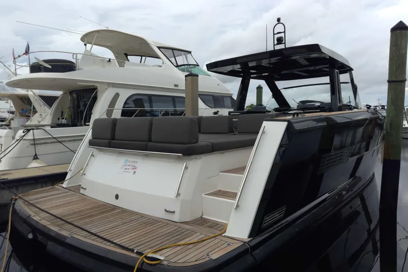 Slide: The Image of 2016 Fjord 48 Open yacht docked at marina, featuring sleek design and spacious deck. - 6