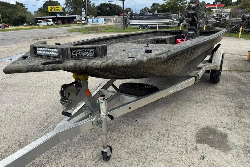 Slide: The Image of 2025 SeaArk 1752 Slayer Pro boat on trailer, featuring camouflage design and LED lights. - 3