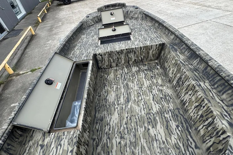 Slide: The Image of 2025 SeaArk 1752 Slayer Pro boat with camouflage interior design. - 8