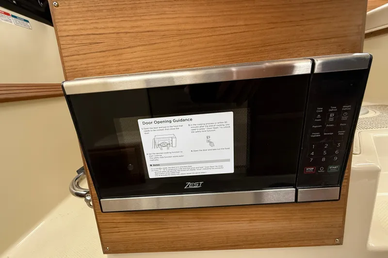 Slide: The Image of 2026 Ranger Tugs R-27 with Yamaha outboard engines at a boat show. - 12