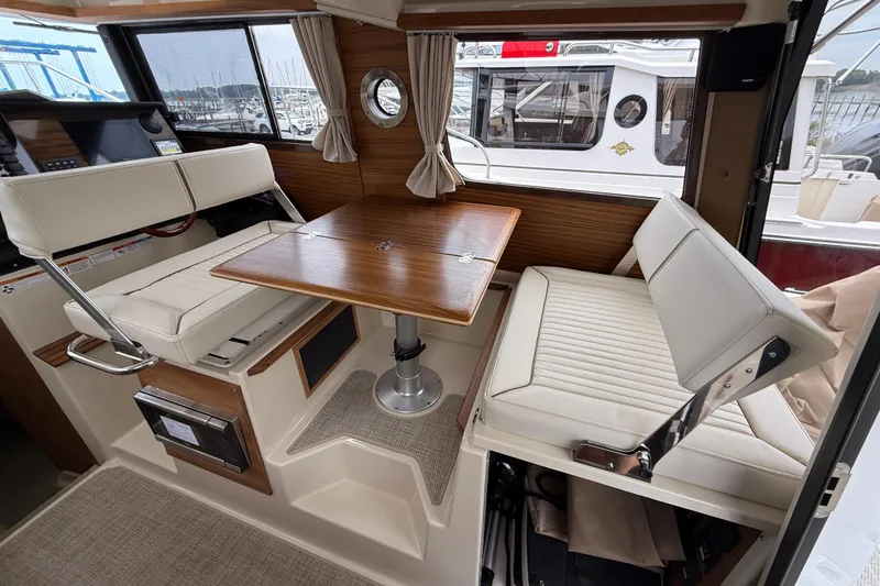 Slide: The Image of 2026 Ranger Tugs R-27 with dual Yamaha 150 outboard engines at dock. - 13