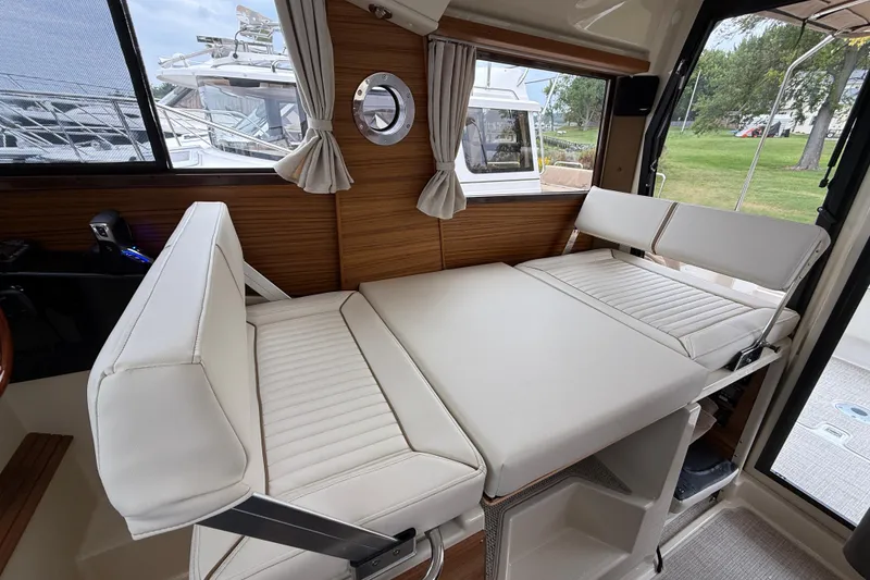 Slide: The Image of 2026 Ranger Tugs R-27 with dual Yamaha 150 outboard engines at a marina. - 14