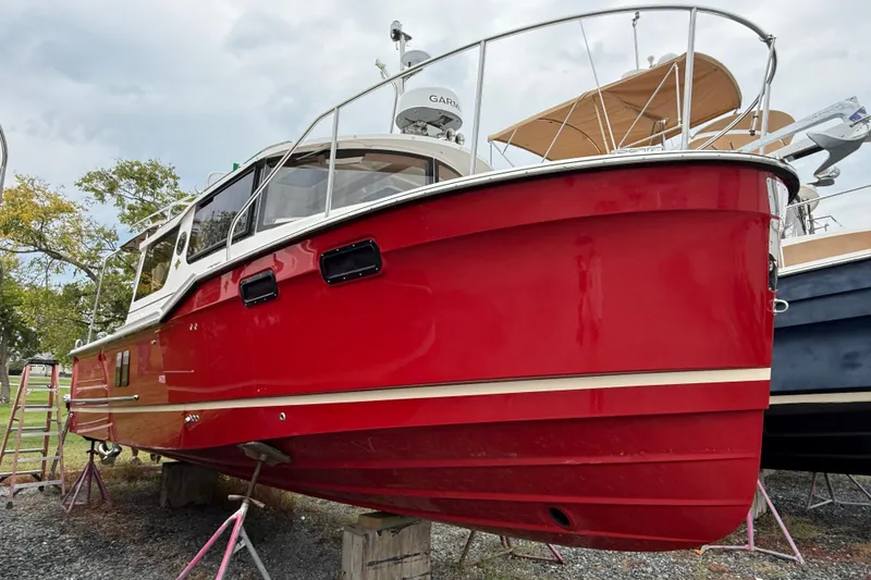 Slide: The Image of 2026 Ranger Tugs R-27 interior kitchen with stove, wooden cabinetry, and modern design. - 19