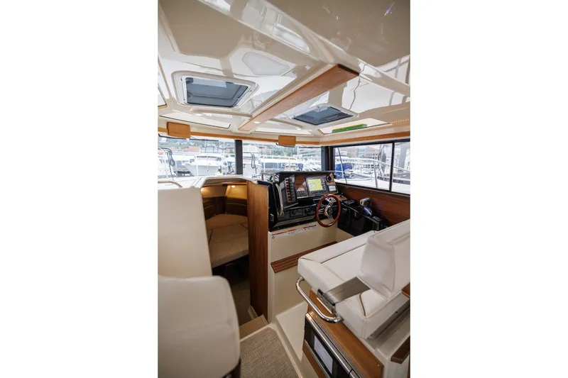 Slide: The Image of Interior of 2026 Ranger Tugs R-27 boat with modern helm and seating. - 24