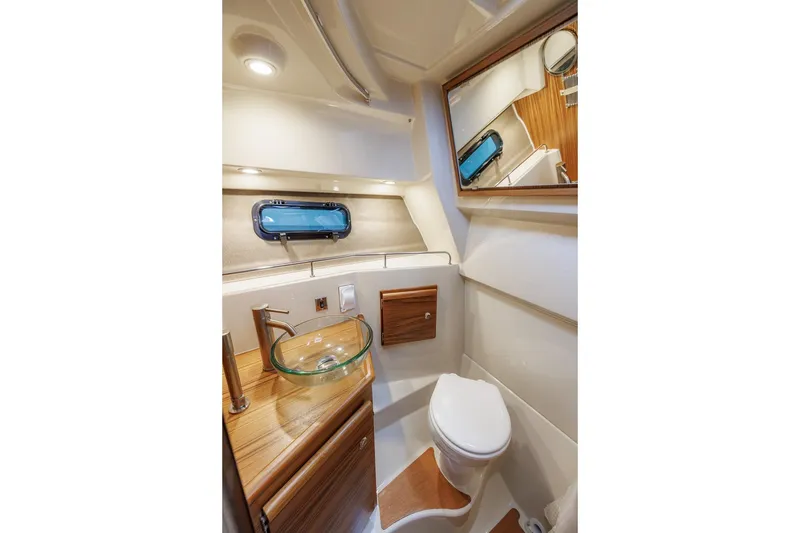 Slide: The Image of Luxurious 2026 Ranger Tugs R-27 boat bathroom with modern fixtures and elegant wood accents. - 26