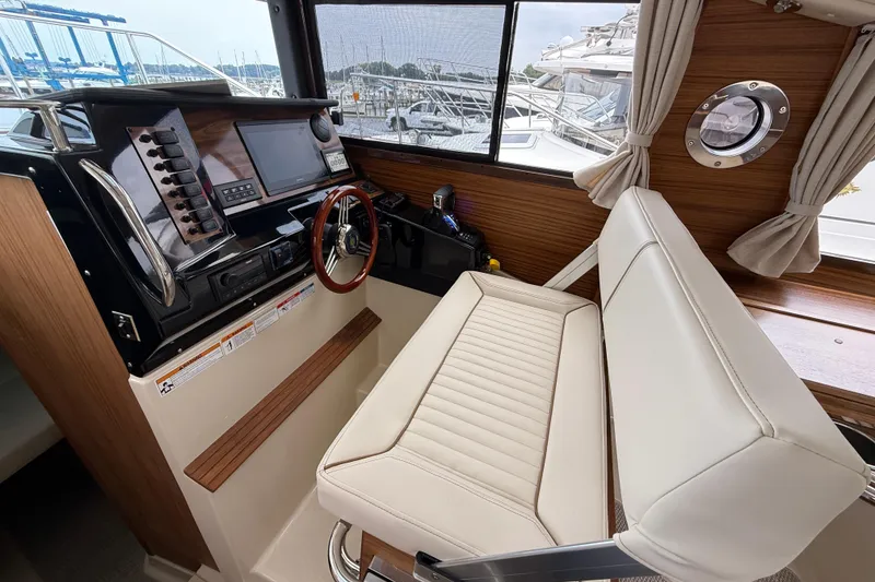 Slide: The Image of 2026 Ranger Tugs R-27 cruising on a scenic lake with dual Yamaha engines. - 7