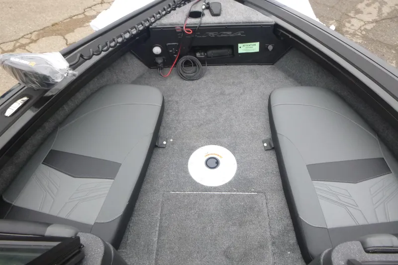 Slide: The Image of 2026 Tracker Targa V-18 Combo boat interior with gray seating and carpeted flooring. - 11