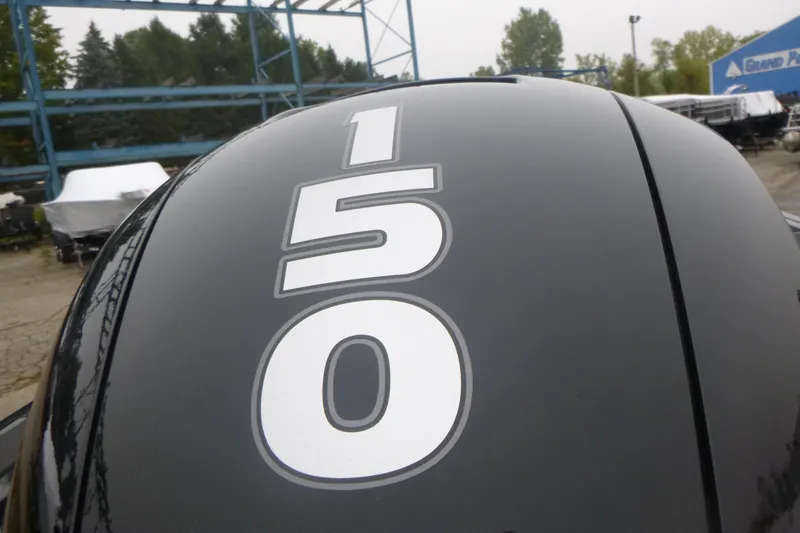 Slide: The Image of Tracker Targa V-18 Combo 2026 boat engine with '150' decal in outdoor setting. - 16