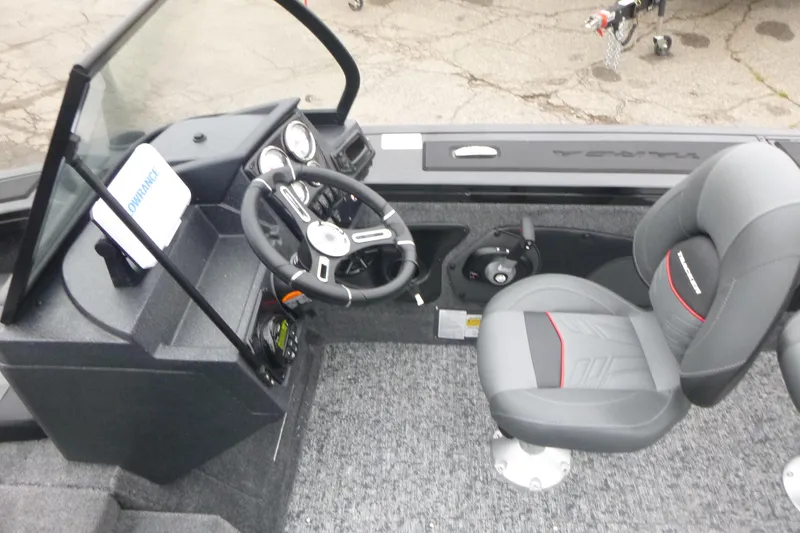 Slide: The Image of 2026 Tracker Targa V-18 Combo boat interior with steering wheel and seating. - 7