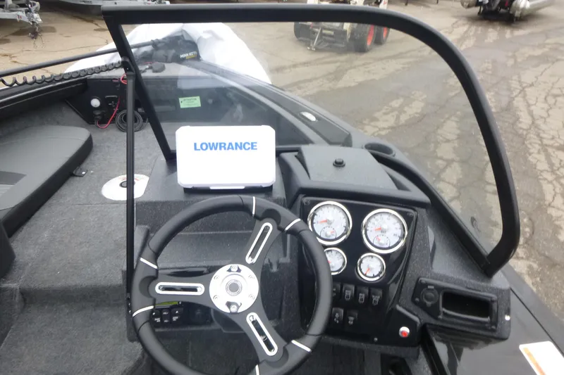 Slide: The Image of 2026 Tracker Targa V-18 Combo boat dashboard with Lowrance display and gauges. - 8
