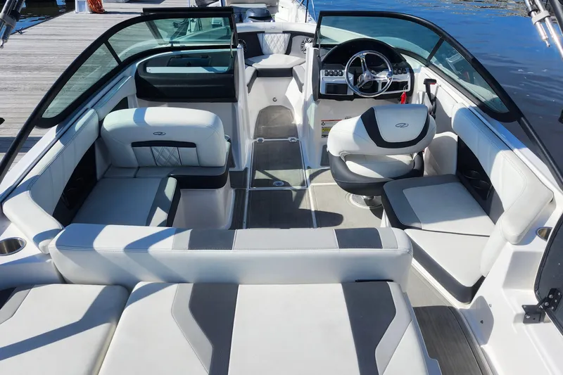 Slide: The Image of 2023 Regal 21 OBX boat interior with modern seating and steering wheel. - 14