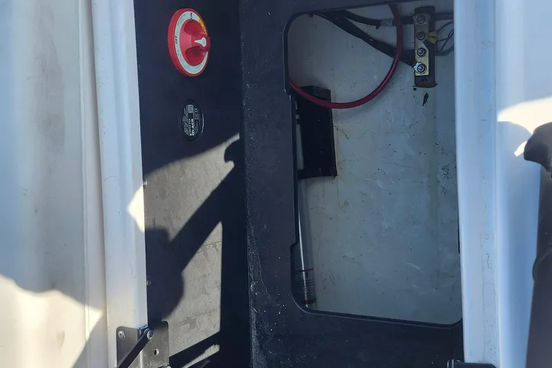 Slide: The Image of 2023 Regal 21 OBX boat interior compartment with wiring and switch. - 22