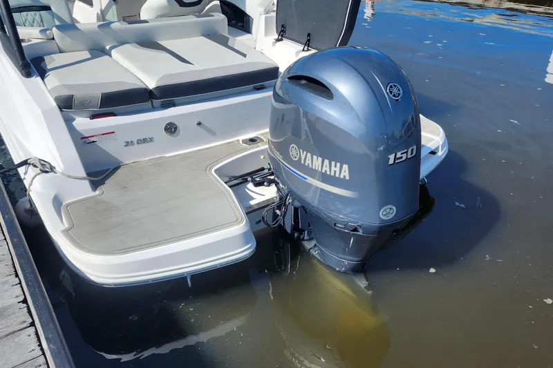Slide: The Image of 2023 Regal 21 OBX boat with Yamaha 150 outboard motor on water. - 25