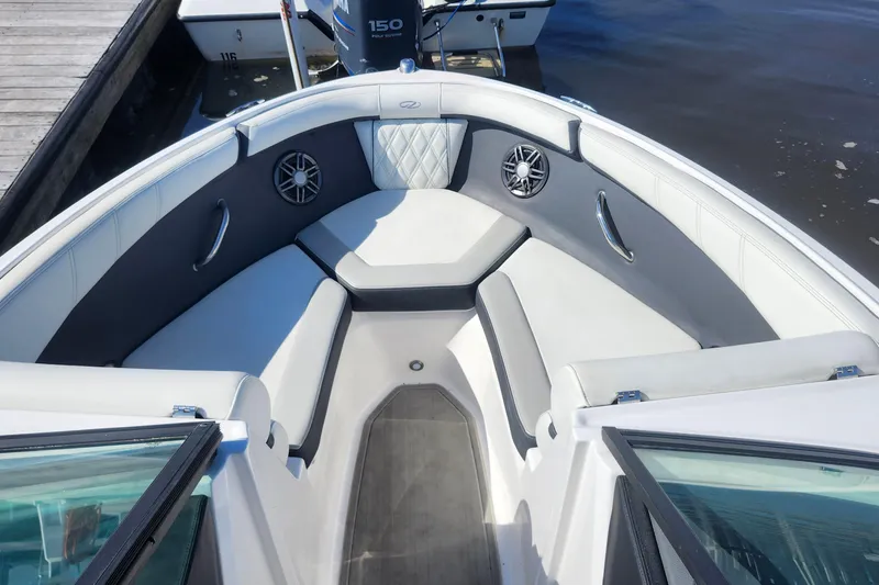 Slide: The Image of 2023 Regal 21 OBX boat interior with cushioned seating and speakers. - 5