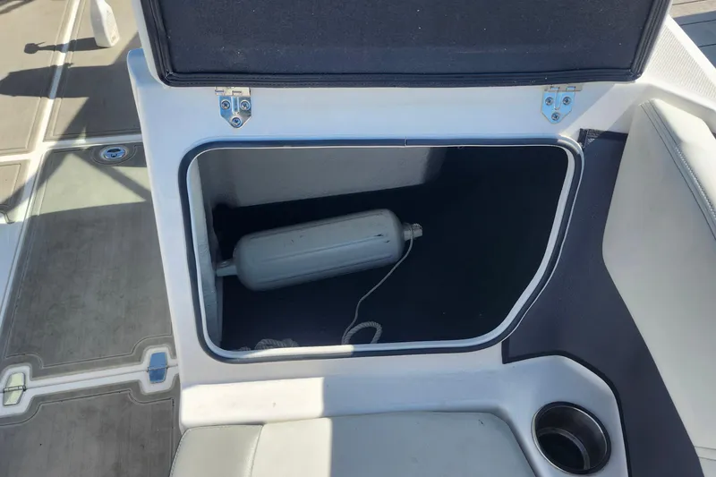 Slide: The Image of Open storage compartment on 2023 Regal 21 OBX boat with fender inside. - 7